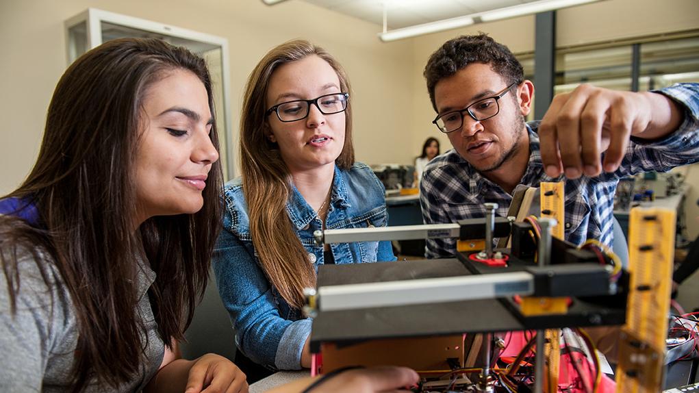 Students wiring electrical engineering project